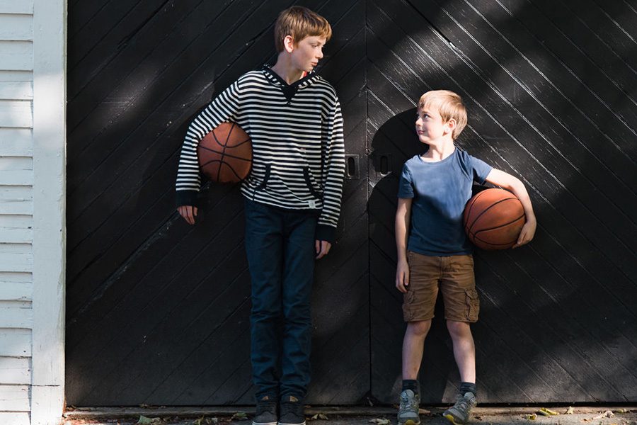 Home Insurance - Two Boys Holding Basketballs Looking at Each Other