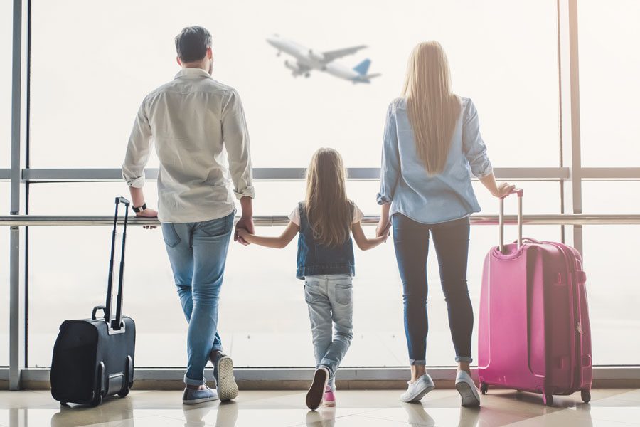 Travel-Insurance-Family-Walking-Through-the-Airport